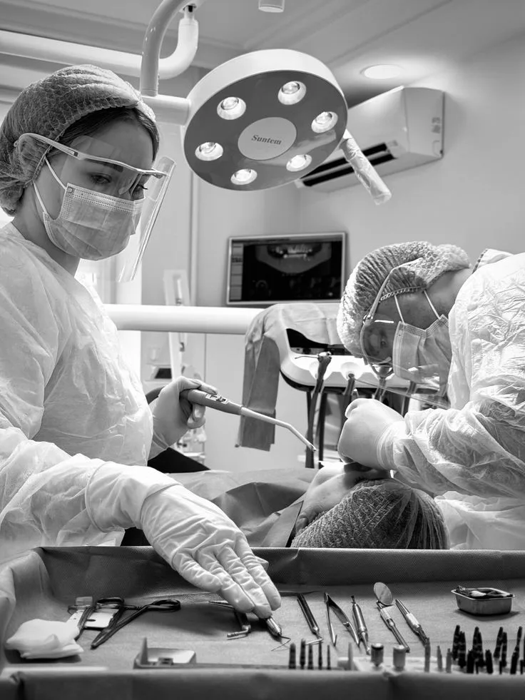 Odontólogos de Prosmile colocando un implante dental en condiciones estériles